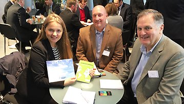 Triinu Varblane from Merinova presents the Cleantech Kvarken  Company Catalogue to Justin Dutram and Bruce A. Wright